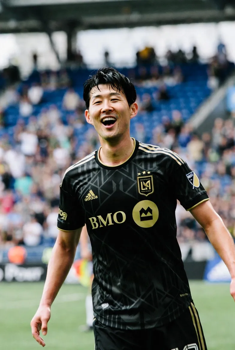 Son Heung-min smiling brightly in an LAFC black and gold jersey at BMO Stadium